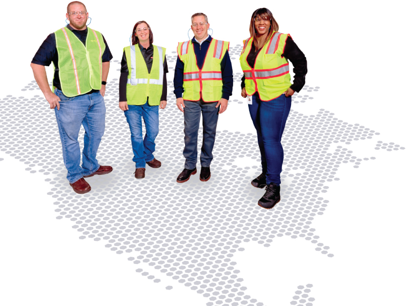 people around a forklift with PECO pallets on a dotted floor shaped into a map of north america